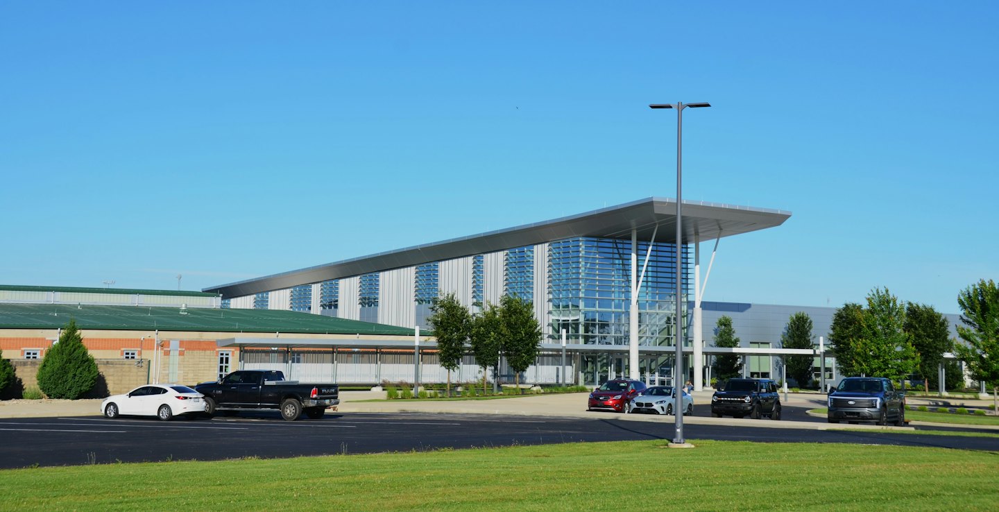 Modern office building with metal louvers and glass windows.